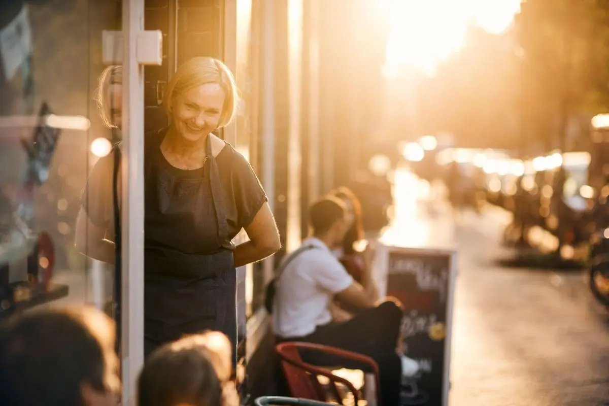 woman business owner smiling at end of the day